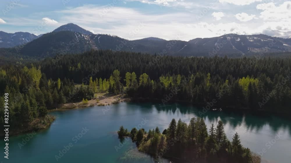 Majestic view of flying over Gold Creek Pond and Evergreen Forest on a blue sky day in Washington State Majestic view of flying over Gold Creek Pond and Evergreen Forest on a blue sky day in Washington State