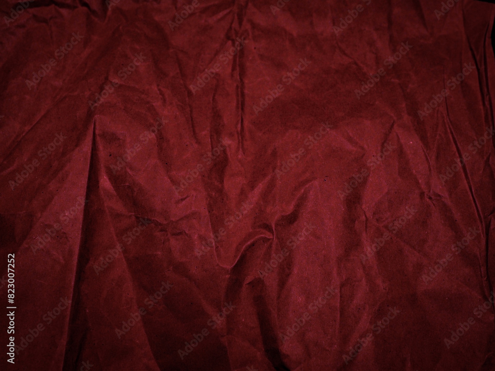 Wrinkled paper texture in dark red tones for a mysterious background. Wrinkled paper texture in dark red tones for a mysterious background.