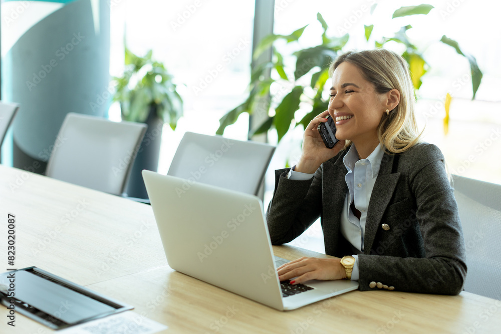 Bright morning business call in modern office setting with greenery Bright morning business call in modern office setting with greenery