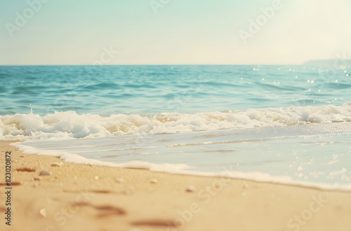 Blurred Sandy Beach with Soft Waves and Blue Sea in Pastel Tones © MD