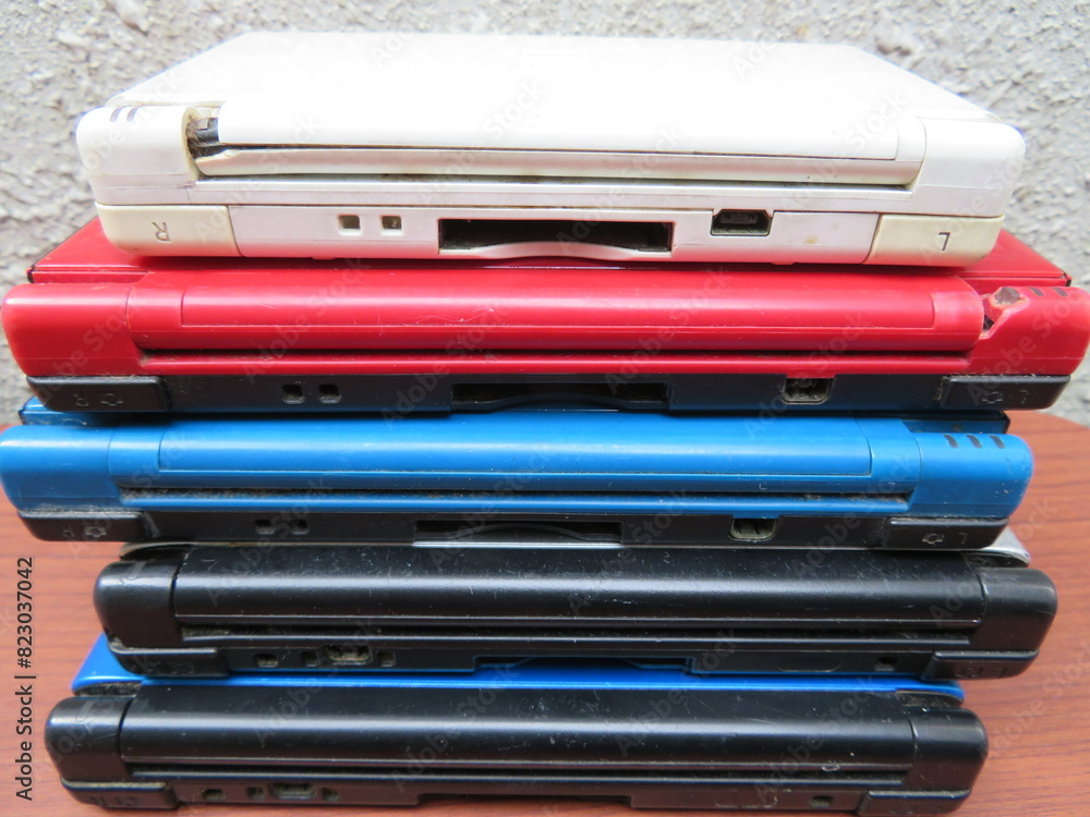 Stack of old handheld video gaming consoles
