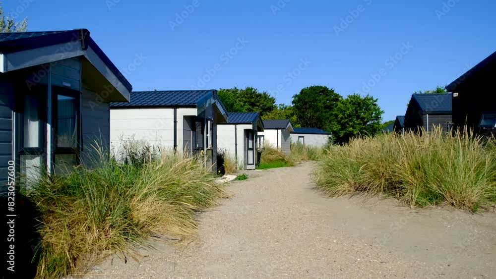 Waterfront summer cabin in rural area surrounded by green vegetation. Waterfront summer cabin in rural area surrounded by green vegetation.
