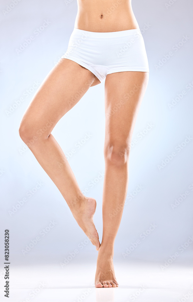 Woman, legs and skincare with underwear in epilation, hair removal or grooming on a blue studio background. Closeup of female person, feet or beauty for laser treatment, cosmetology or dermatology Woman, legs and skincare with underwear in epilation, hair removal or grooming on a blue studio background. Closeup of female person, feet or beauty for laser treatment, cosmetology or dermatology