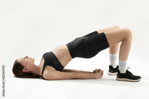 Young woman practicing stretching yoga positions, wellbeing and self care concept