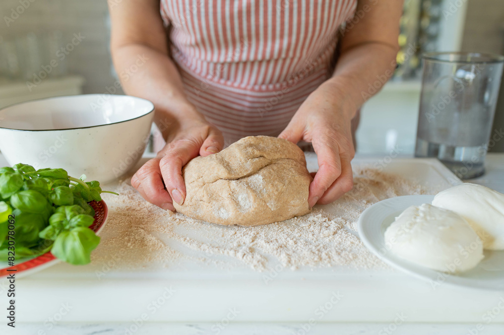 Hands holding a fresh kneaded whole wheat pizza dough Hands holding a fresh kneaded whole wheat pizza dough