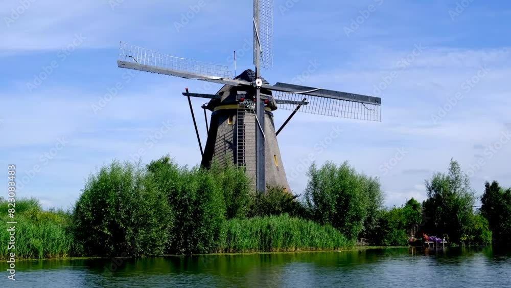 Traditional windmill on a canal in the village of Kinderdijk, South Holland, Netherlands. Traditional windmill on a canal in the village of Kinderdijk, South Holland, Netherlands.
