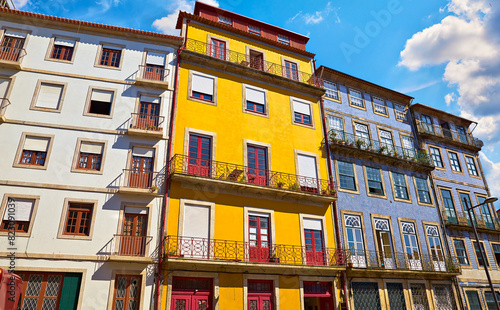 Porto, Portugal. Cosy street with traditional colorful houses. Windows and sun. Sunny summer day. Residential porto city district beautiful antique portugal buildings. Travel destination in Europe