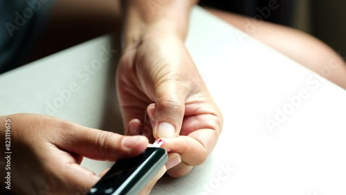 Woman's hands checking diabetes and hyperglycemia with digital blood sugar meter. Healthcare and medical concept photo