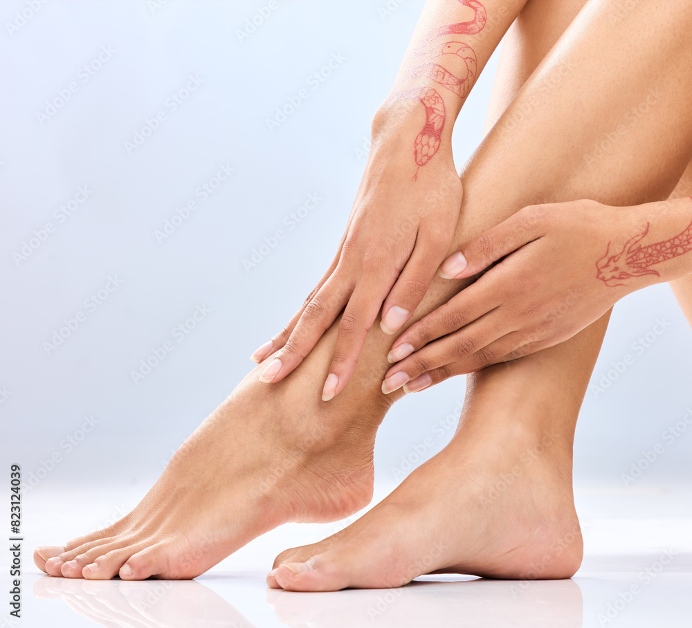 Fototapeta premium Woman, legs and hands with depilation in skincare, grooming or hair removal waxing on a blue studio background. Closeup of female person, feet or beauty in laser treatment, cosmetology or dermatology