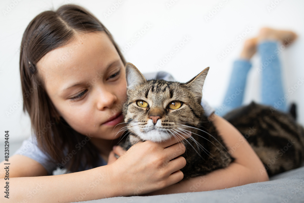 Portrait of little adorable gray cat and little girl indoors Portrait of little adorable gray cat and little girl indoors