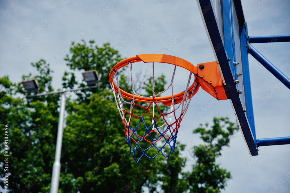 basketball hoop against a background of wood and blue sky close-up basketball hoop against a background of wood and blue sky close-up