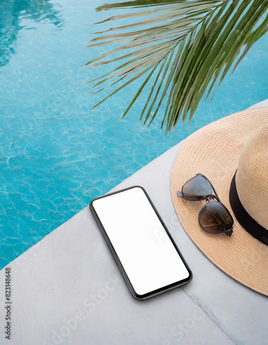 Smart phone mockup on swiiming pool under palm shadow, tropical vacation concept photo