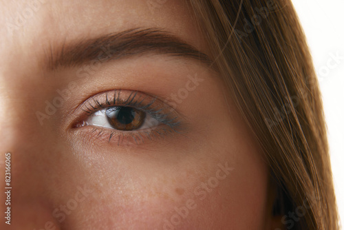 Close-up photo of woman's eye, highlighting well-defined eyebrow, long eyelashes, and smooth skin. Concept of beauty, make up, natural cosmetic, facecare, healthcare. Ad photo