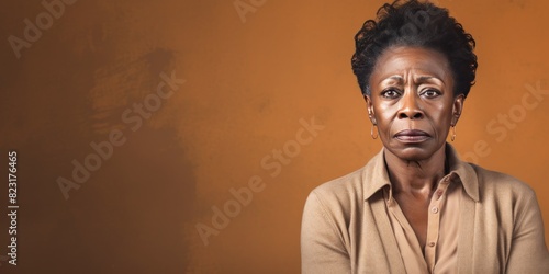 Beige background sad black american independant powerful Woman realistic person portrait of older mid aged person beautiful bad mood expression Isolated 
