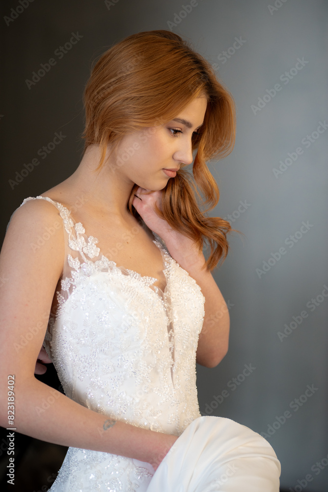 Beautiful young woman bride in fashion wedding dress in white interior Beautiful young woman bride in fashion wedding dress in white interior