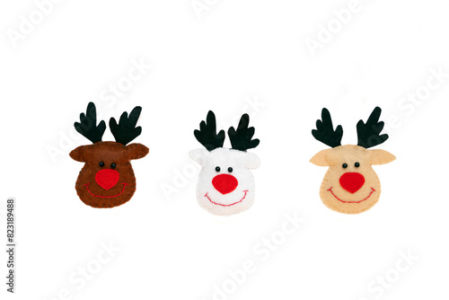 Toy Deers hanging on a rope isolated on the white background with copy space. The atmosphere of Christmas and New Year. Christmas banner, mock-up