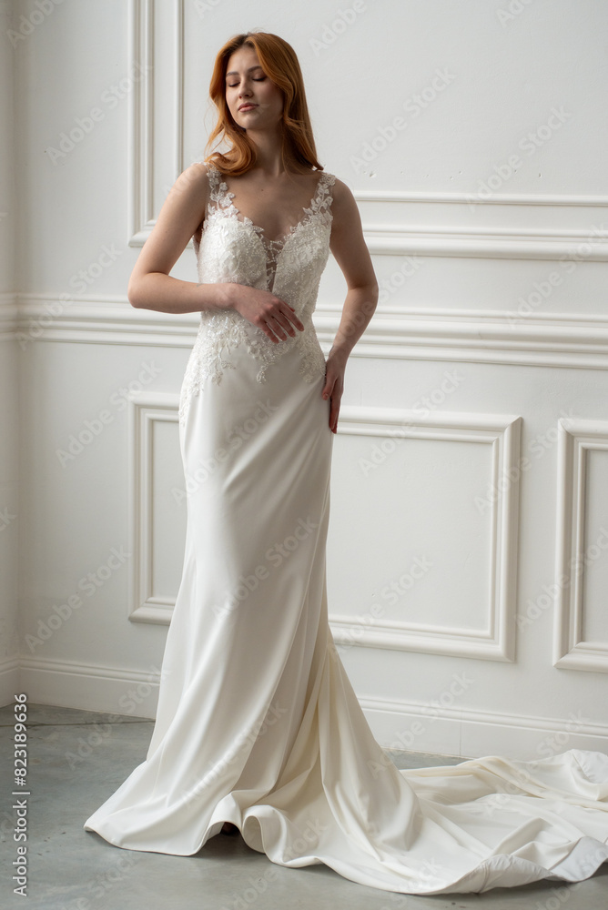 Beautiful young woman bride in fashion wedding dress in white interior Beautiful young woman bride in fashion wedding dress in white interior
