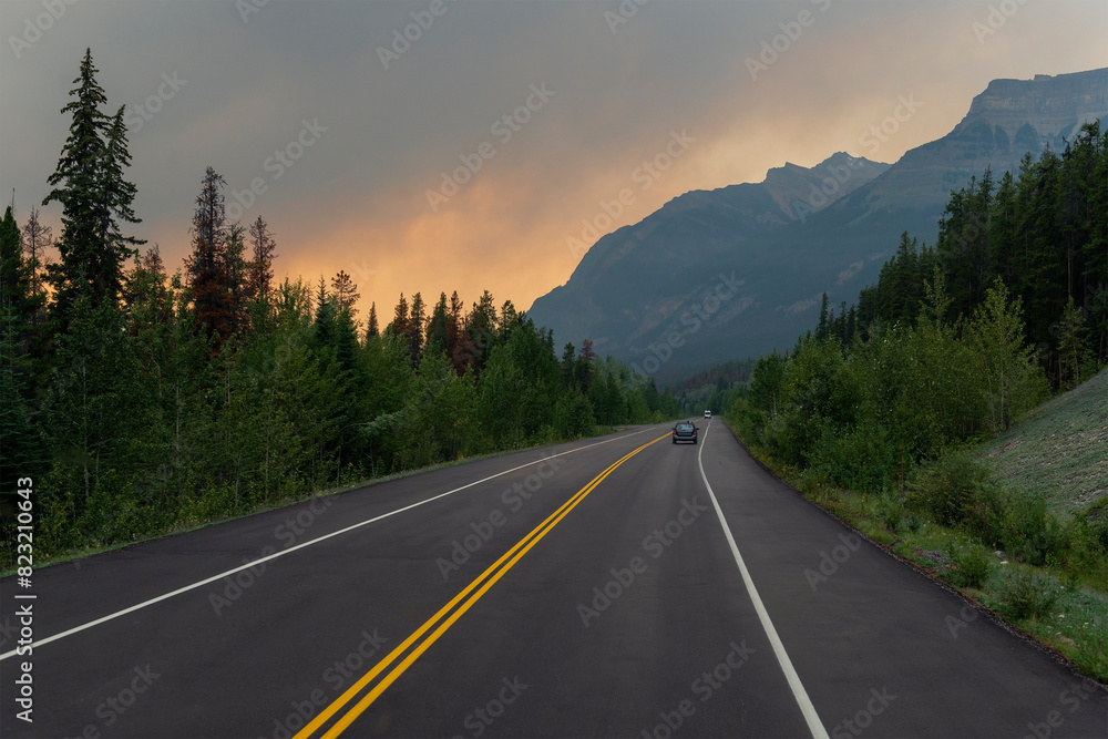 Dramatic landscape with smoke clouds along highway in British Columbia during wildfires, Canada.