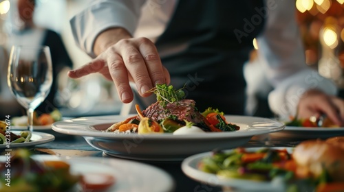 Close up view of a chef's hands arranging dishes on a ceramic plate preparing dinner salad menu dishes at a restaurant.
