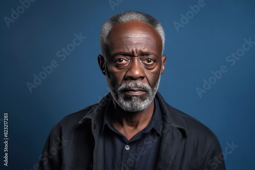 Cream background sad black american independent powerful man. Portrait of older mid-aged person beautiful bad mood expression isolated on background racism skin color depression anxiety fear burnout 