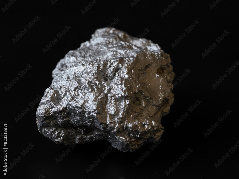 Closeup pure silver nugget from the mine on black background. Finance and business concept. Closeup pure silver nugget from the mine on black background. Finance and business concept.