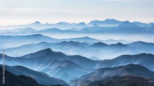 A panoramic view reveals mountain ranges fading into the mist, blending earthy silhouettes with soft hues.