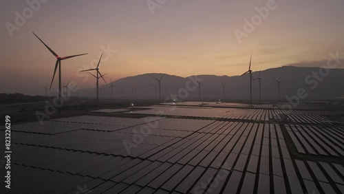 Wind power and Solar in sunrise at Ninh Thuan province, Vietnam - Aerial view 4k high quality