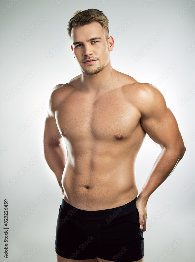 Muscle, strong and body of man for fitness, health and exercise for training goal on white studio background. Portrait, sports and bodybuilder model with sexy, young and healthy abs from sports