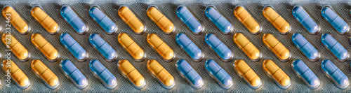 Blue and yellow pills - capsules are packed in a blister and alternate in color in vertical rows. Medical background with medicines for business, industry, pharmacies, clinics.