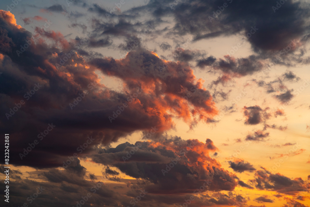 A stunning display of dramatic clouds illuminated by the vibrant colors of a sunset, showcasing the beauty and complexity of nature's evening skies. Perfect for backgrounds and atmospheric scenes. A stunning display of dramatic clouds illuminated by the vibrant colors of a sunset, showcasing the beauty and complexity of nature's evening skies. Perfect for backgrounds and atmospheric scenes.