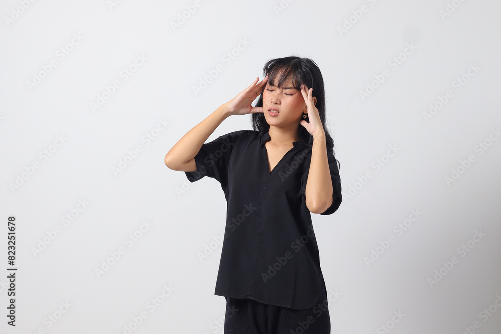 Portrait of overwhelmed Asian woman in casual shirt touching her head, having headache, and feeling stressed. Businesswoman concept. Isolated image on white background Portrait of overwhelmed Asian woman in casual shirt touching her head, having headache, and feeling stressed. Businesswoman concept. Isolated image on white background