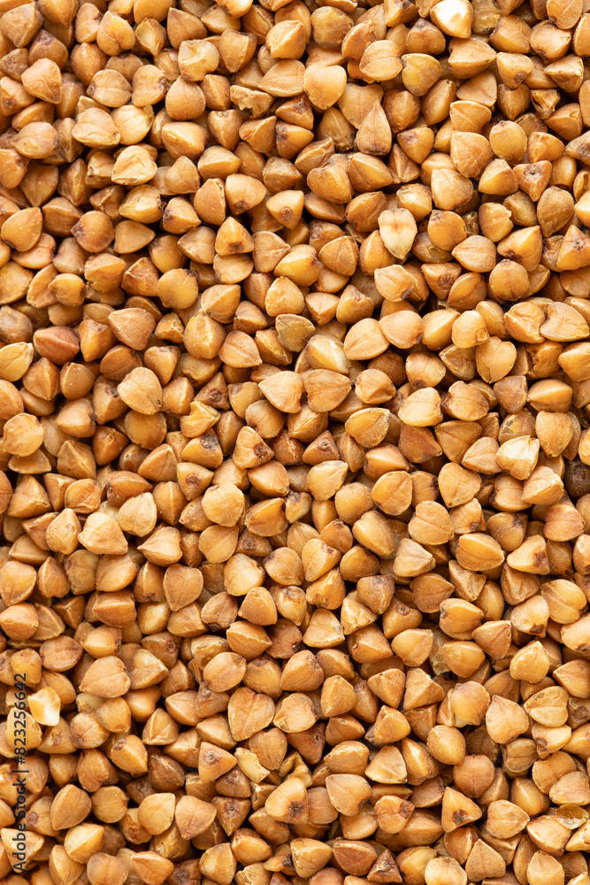 Buckwheat grain. Buckwheat texture. Macro photograph of buckwheat. Healthy eating background. Buckwheat grain. Buckwheat texture. Macro photograph of buckwheat. Healthy eating background.