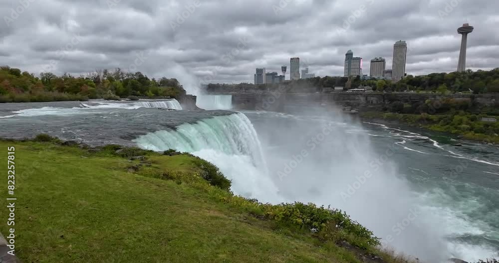 Niagara Falls taken from the American side overlooking the Canadian side with the water strongly falling down from the waterfall. Niagara Falls taken from the American side overlooking the Canadian side with the water strongly falling down from the waterfall.