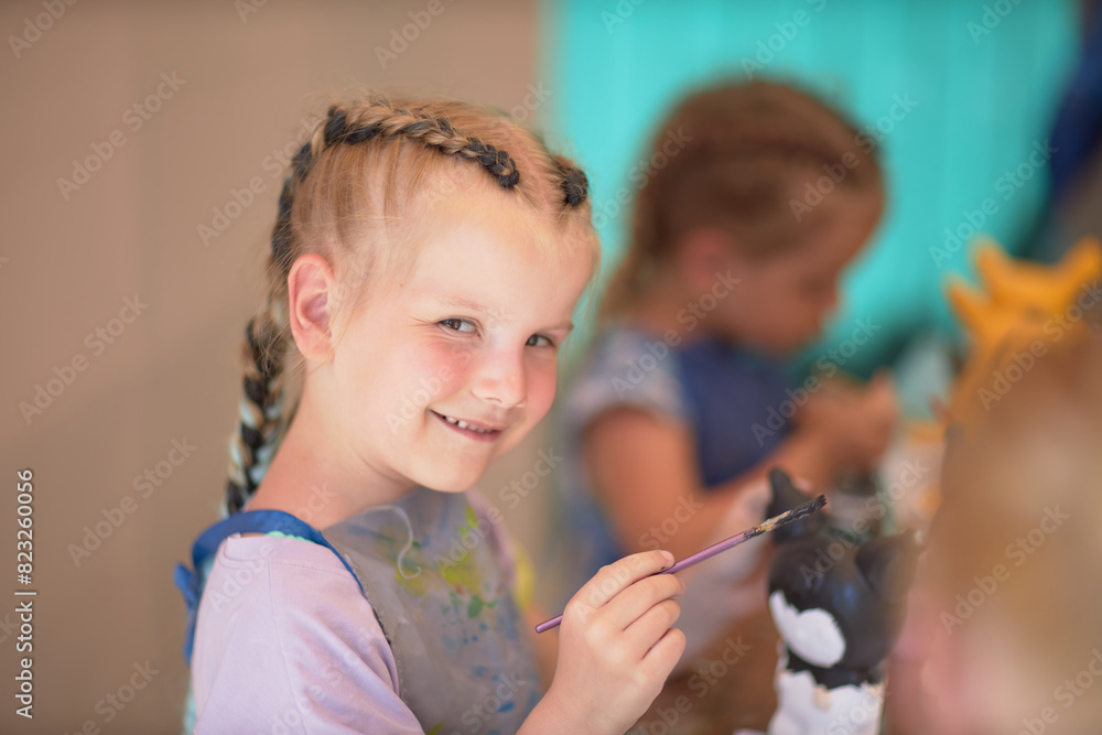 Girls 4-5 years old are sitting at a table and painting with colorful paints. Children's creativity. Children's hobbies. Girls 4-5 years old are sitting at a table and painting with colorful paints. Children's creativity. Children's hobbies.