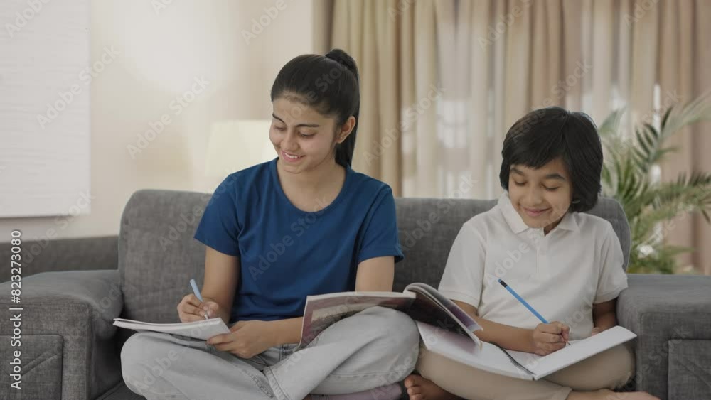 Happy Indian sibling studying at home Happy Indian sibling studying at home