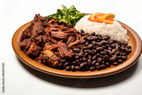 Hearty feijoada on a palm leaf plate against a white background