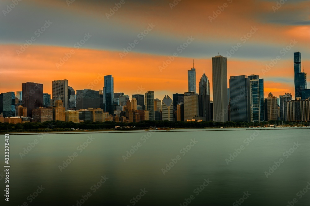 Scenic view of a cityscape against the sea at orange sunset Scenic view of a cityscape against the sea at orange sunset