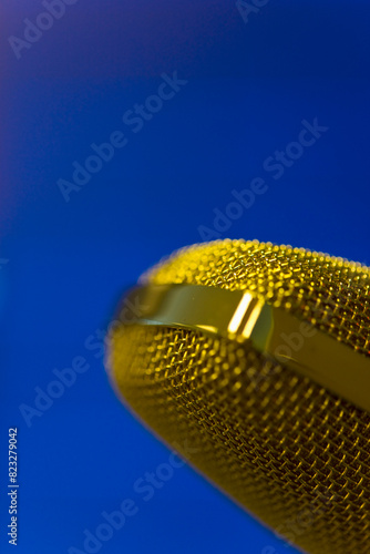 Extreme close up of a gold microphone
 photo