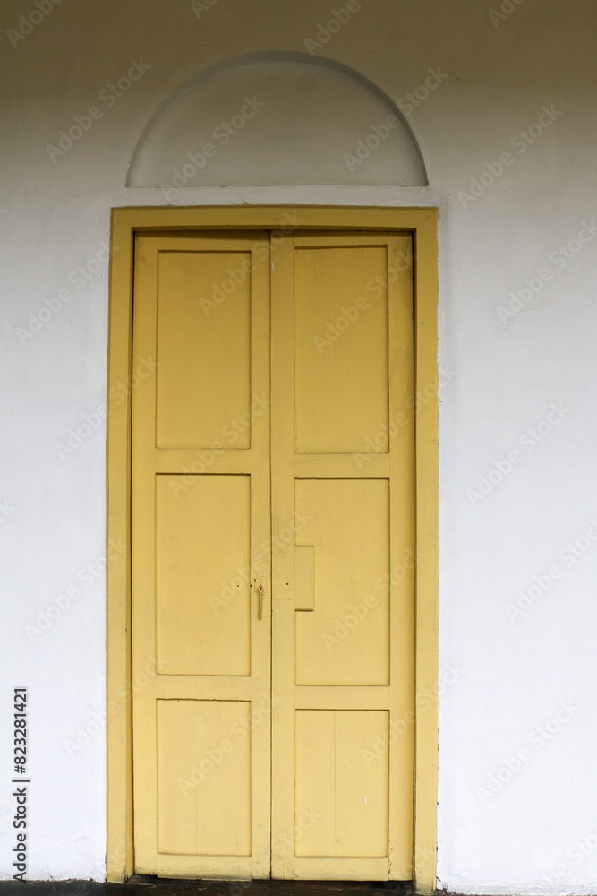 Yellow door in a wall