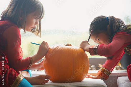 Young Girls Making a Pumpkin Lantern
 photo