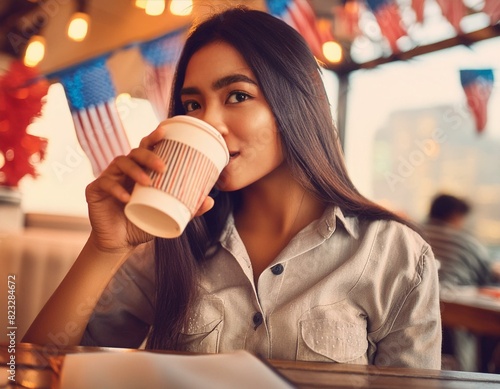 Creative concept image of happy young woman sitting at the cafe with holiday 4th of July decorations flags celebrating and drinking coffee in cup mug.