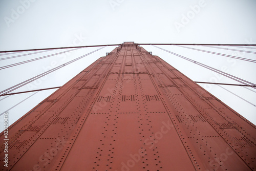 Low-angle shot of the tower of Golden Gate Bridge against the backdrop of the sky