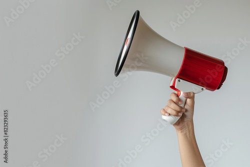 woman hand is holding megaphone isolated on white background,announcement concept in business topic,selective focus,copy space 