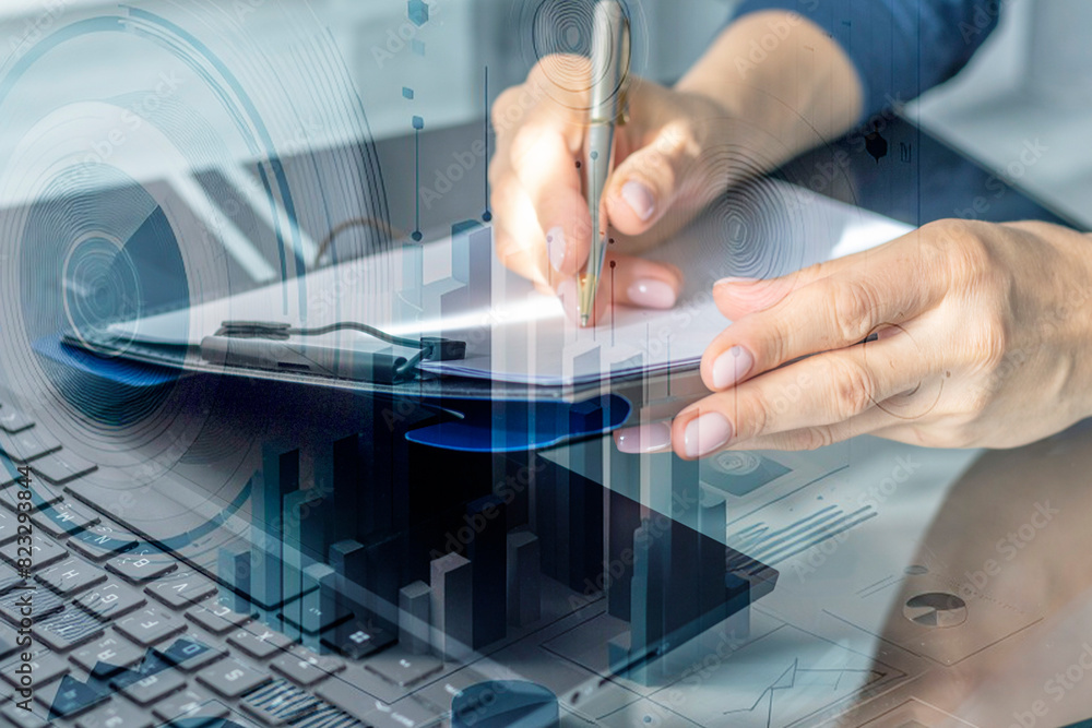 Close up shot of the woman with beautiful hands in the business attire, working on the tablet in the office, making notes. Trading charts on the foreground. Industry Close up shot of the woman with beautiful hands in the business attire, working on the tablet in the office, making notes. Trading charts on the foreground. Industry