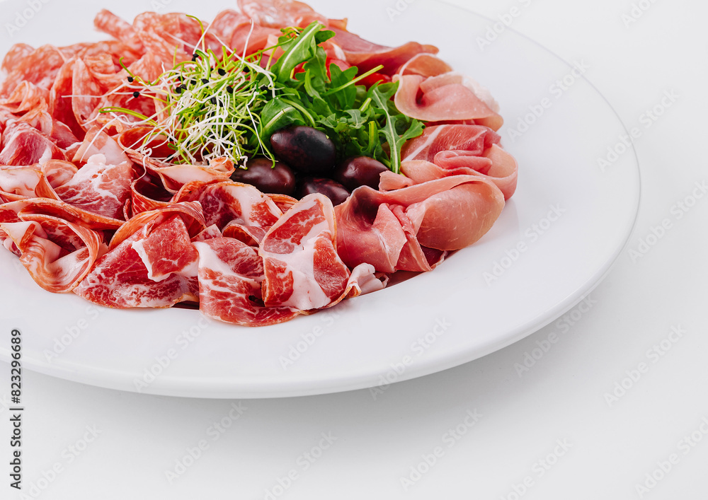 Assorted deli meats plate with garnish Assorted deli meats plate with garnish