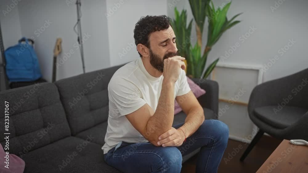 Stressed middle-aged man at home fearfully biting nails, vulnerable expression reflecting life's pressures and anxiety Stressed middle-aged man at home fearfully biting nails, vulnerable expression reflecting life's pressures and anxiety