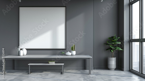 A modern real estate office with a blank frame under a grey table, deep grey wall providing a professional and clean look.