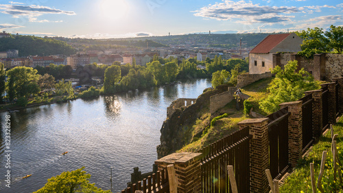 Photography A view of the Vltava River from Prague's Vyšehrad at sunset with the vineyard in the foreground and the historic walls