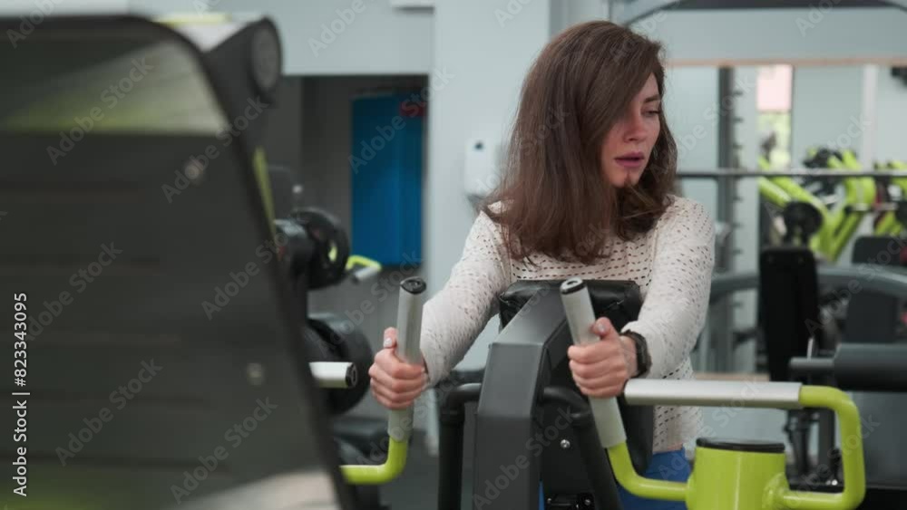 Young Woman Working Out on Chest Press Machine in Modern Gym Young Woman Working Out on Chest Press Machine in Modern Gym