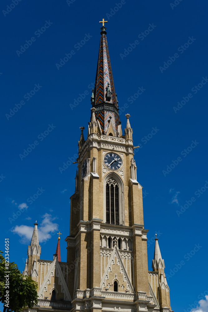 Name of Mary Church, also known as Novi Sad catholic cathedral or crkva imena marijinog during a sunny day. The cathedral is one of the most important landmarks. Tower with clock close view.